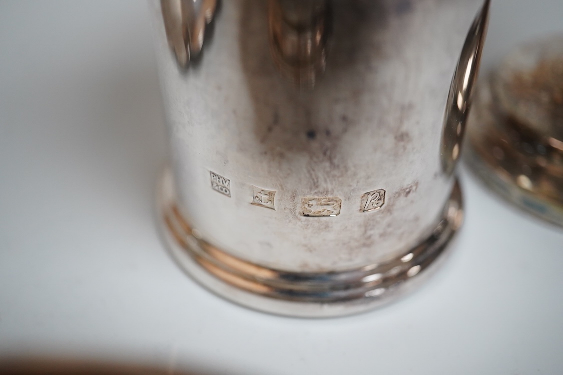 A modern silver oval pedestal sweetmeat bowl, by Mappin & Webb, Birmingham, 1987, 15.8cm, together with a small silver bottle holder, a silver mounted vase and a sterling two handled nut dish.